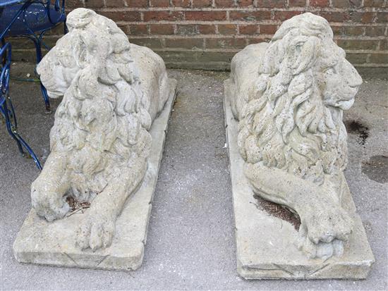 A pair of reconstituted stone garden statues modelled as seated lions, 4ft